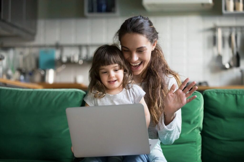 Baby and mother talking in online smiling